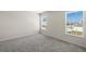 Well-lit bedroom with gray carpet, neutral walls, and two windows at 164 Holly Village Dr, Davenport, FL 33837