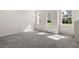 Open entryway with neutral carpet and natural light at 164 Holly Village Dr, Davenport, FL 33837