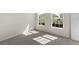 Well-lit bedroom featuring grey carpet and two large windows at 164 Holly Village Dr, Davenport, FL 33837