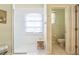 Bathroom with shower, tub, and toilet. Features patterned tile floor and window at 9868 Montclair Cir, Apopka, FL 32703