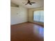 Living room with laminate wood flooring and window coverings at 2421 Omaha Dr, Deltona, FL 32738