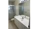 Clean bathroom with a white vanity, shower, and pebble floor at 2421 Omaha Dr, Deltona, FL 32738