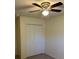Bedroom with ceiling fan and double door closet at 2421 Omaha Dr, Deltona, FL 32738