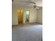 Spacious bedroom with carpeting, ceiling fan, and access to a bathroom and walk-in closet at 2421 Omaha Dr, Deltona, FL 32738