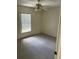 Bright bedroom featuring a ceiling fan and window with blinds at 2421 Omaha Dr, Deltona, FL 32738