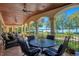 Outdoor patio furniture on a covered porch with a lake view at 1900 W Fawsett Rd, Winter Park, FL 32789