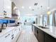 Open concept kitchen with island and stainless steel appliances at 128 Hampton Loop, Davenport, FL 33837