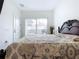 Bedroom with king-size bed and sliding doors leading to a pool view at 128 Hampton Loop, Davenport, FL 33837