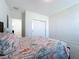 Bright bedroom with flamingo bedding and double door closet at 128 Hampton Loop, Davenport, FL 33837