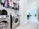 Laundry room with washer, dryer, and overhead storage at 128 Hampton Loop, Davenport, FL 33837