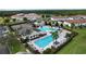 Community pool and tennis courts with surrounding homes at 128 Hampton Loop, Davenport, FL 33837