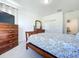 Cozy bedroom with a dresser, TV, and window with tree views at 128 Hampton Loop, Davenport, FL 33837