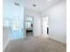 Upstairs hallway with carpet and access to bedrooms and bathrooms at 128 Hampton Loop, Davenport, FL 33837