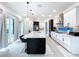 Modern kitchen with large island, stainless steel appliances, and pool view at 128 Hampton Loop, Davenport, FL 33837