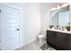 Small bathroom with dark vanity, white toilet, and black accents at 128 Hampton Loop, Davenport, FL 33837