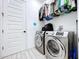 Bright laundry room with washer, dryer and storage at 128 Hampton Loop, Davenport, FL 33837