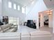 Spacious living area with high ceilings, sectional sofa, and view of bedroom at 128 Hampton Loop, Davenport, FL 33837