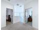 Upstairs hallway with carpet and access to bedrooms at 128 Hampton Loop, Davenport, FL 33837