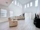 Spacious living room with high ceilings, light walls, and sectional sofa at 128 Hampton Loop, Davenport, FL 33837
