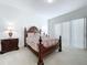 Bedroom with a queen-size bed and sliding door access at 128 Hampton Loop, Davenport, FL 33837