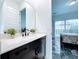 Modern bathroom with dark vanity and quartz countertop at 128 Hampton Loop, Davenport, FL 33837