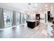 Modern kitchen with island, stainless steel appliances, and pool view at 128 Hampton Loop, Davenport, FL 33837