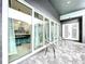 Covered patio with glass doors overlooking the pool at 128 Hampton Loop, Davenport, FL 33837