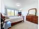 Bright bedroom with a wooden bed frame and ample closet space at 128 Hampton Loop, Davenport, FL 33837