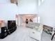 Open concept living area with high ceilings and light flooring at 128 Hampton Loop, Davenport, FL 33837