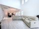 Open living room with high ceilings, large sectional sofa, and view of kitchen at 128 Hampton Loop, Davenport, FL 33837
