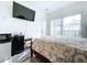 Bedroom with king-size bed, mini-fridge, and pool view at 128 Hampton Loop, Davenport, FL 33837