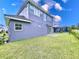 Gray house with a grassy backyard, patio, and pool at 128 Hampton Loop, Davenport, FL 33837