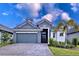Modern two-story house with gray exterior and two-car garage at 128 Hampton Loop, Davenport, FL 33837