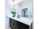 Modern bathroom with dark vanity and white quartz countertop at 128 Hampton Loop, Davenport, FL 33837