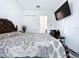 Spacious bedroom with king-size bed and en-suite bathroom access at 128 Hampton Loop, Davenport, FL 33837