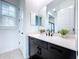 Clean bathroom with dark vanity and quartz countertop at 128 Hampton Loop, Davenport, FL 33837