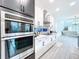 Modern kitchen with double oven and sleek countertops at 128 Hampton Loop, Davenport, FL 33837