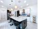 Modern kitchen with a large island, stainless steel appliances, and white cabinets at 128 Hampton Loop, Davenport, FL 33837