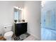 Clean powder room with modern vanity and dark cabinets at 128 Hampton Loop, Davenport, FL 33837