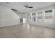 Living room with tile flooring, large windows, ceiling fan, and staircase to upper level at 15524 Blackbead St, Winter Garden, FL 34787