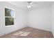 Well-lit bedroom featuring a large window and ceiling fan at 4190 Rossmore Dr, Orlando, FL 32810