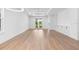 Bright and airy living room featuring hardwood floors and French doors leading to the backyard at 4190 Rossmore Dr, Orlando, FL 32810