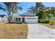 A charming craftsman style home with a white exterior and attached two-car garage at 4190 Rossmore Dr, Orlando, FL 32810