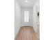 Bright entryway with light wood flooring and a white door at 4190 Rossmore Dr, Orlando, FL 32810