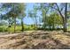 Spacious backyard with mature trees and lake views at 4190 Rossmore Dr, Orlando, FL 32810