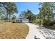 Newly built home with gray siding, a two-car garage, and a landscaped yard at 4190 Rossmore Dr, Orlando, FL 32810