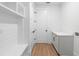 Functional laundry room offering built-in storage and a clean design at 4190 Rossmore Dr, Orlando, FL 32810