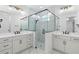 Modern bathroom with double vanity, quartz countertops, and a glass shower at 4190 Rossmore Dr, Orlando, FL 32810