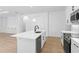 Modern white kitchen with stainless steel appliances and an island at 4190 Rossmore Dr, Orlando, FL 32810