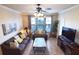 Living room with gray sofas, a coffee table, and a view from large windows at 914 Charo Pkwy # 114, Davenport, FL 33897